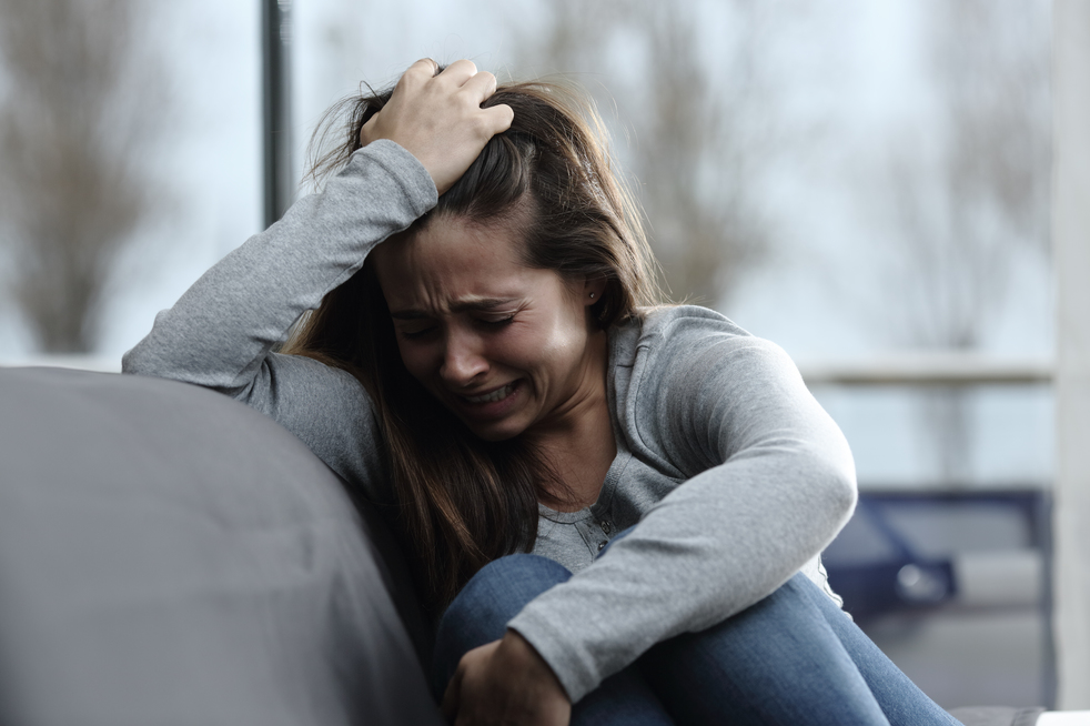 A woman crying because of her cheating husband