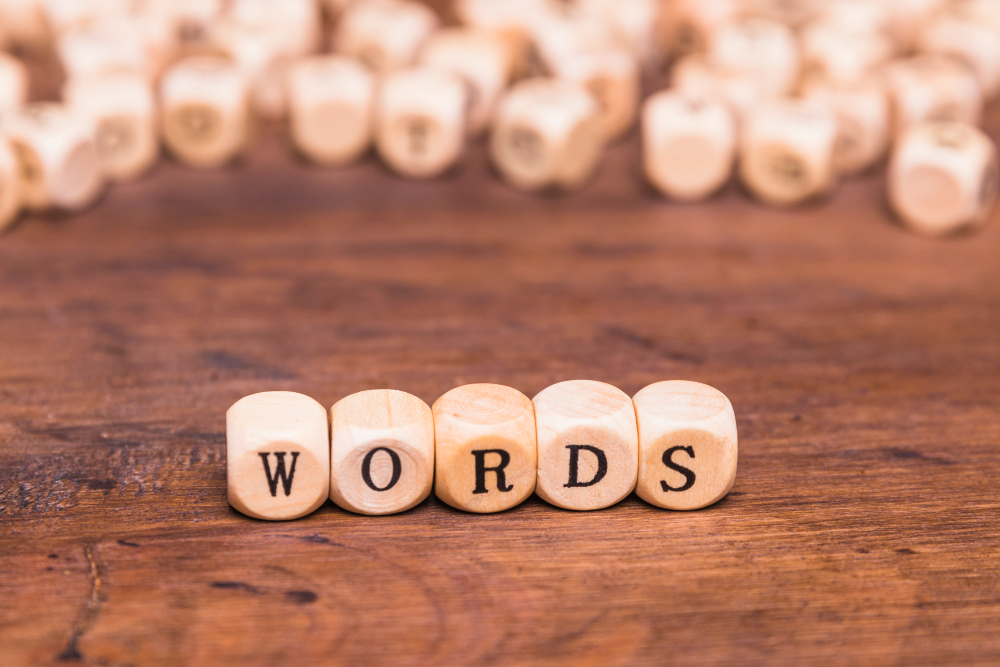 The word “words” is written with wooden letters.